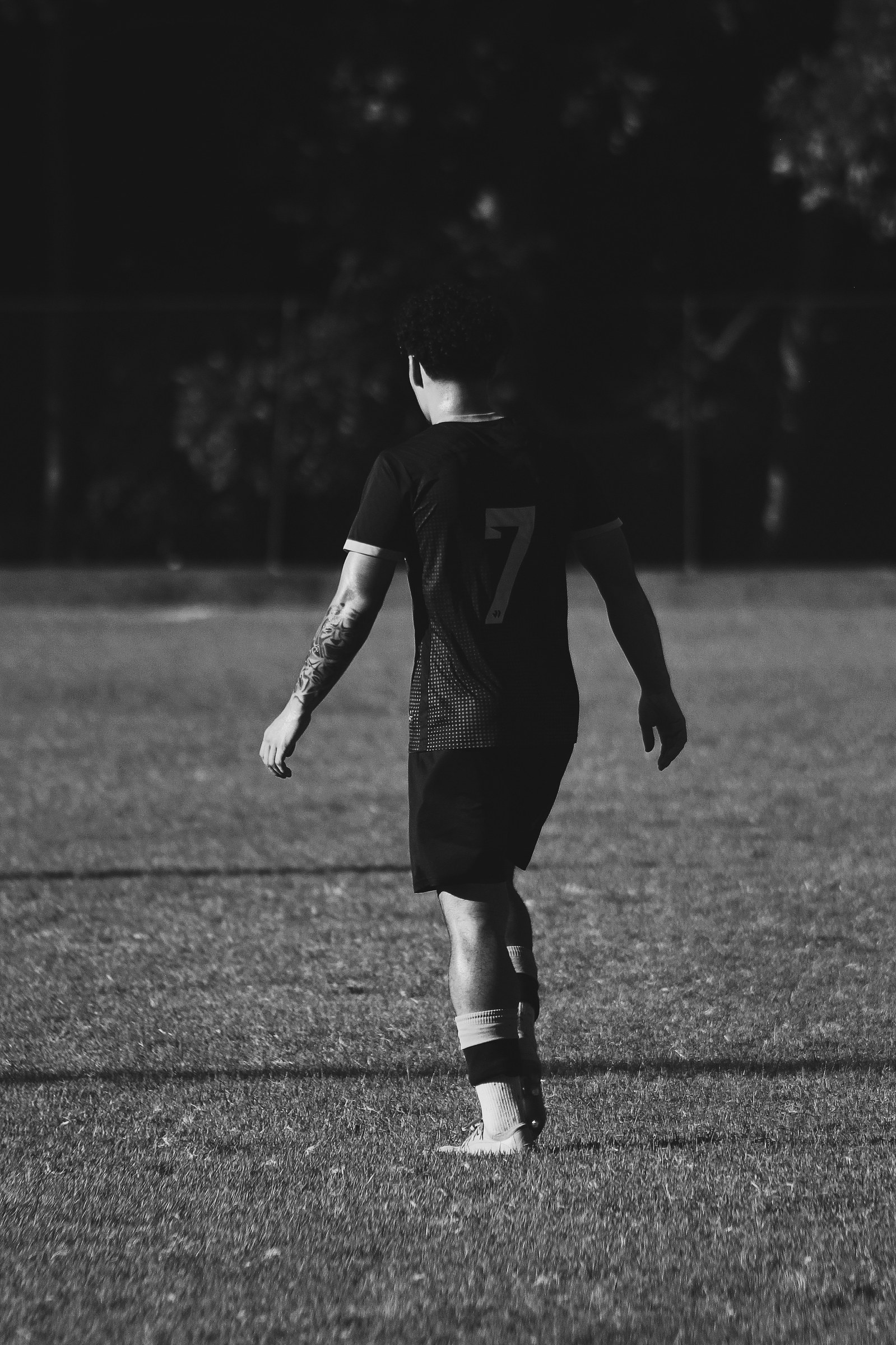 Nathanael Vasiliadis walking on the pitch in number 7 kit